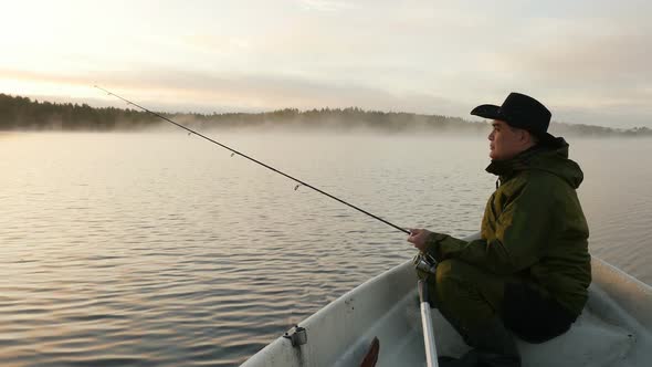 Adult Man Fishing from Motorboat 