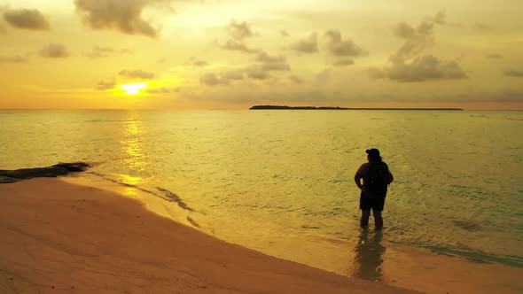 Girl happy and smiling on relaxing coastline beach vacation by turquoise lagoon and white sand backg alt
