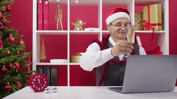 Employee in Santa Hat Wishes Merry Christmas To Colleagues and Family Online