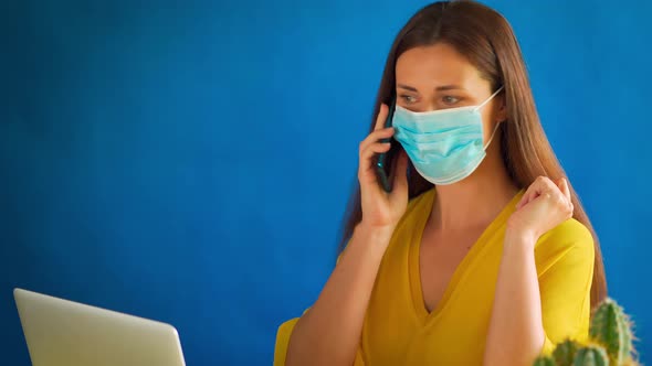 Woman in a Yellow Blouse Works Remotely at Home During a Pandemic alt