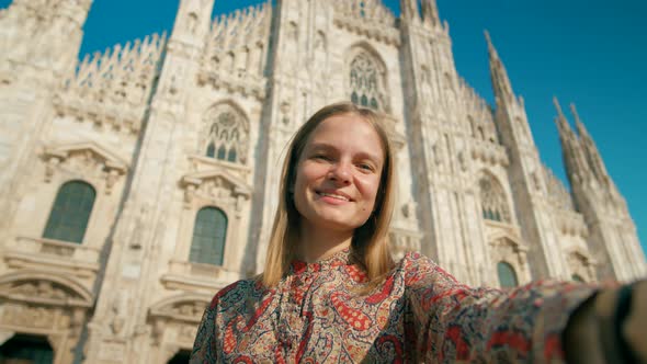 Woman Takes Photo or Video By Smart Phone with Landmark Milan Cathedral Italy