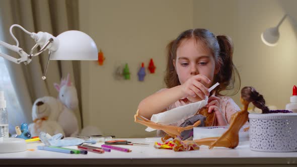Cute Preschool Girl Invents Clothes for Dolls alt
