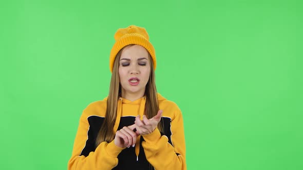 Portrait of Modern Girl in Yellow Hat Is Counting at Fingers, Remembering Something, Then Scolding alt