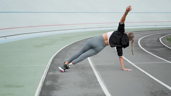 Disabled Athlete Standing in Plank on Hand at Track. Girl Practicing Yoga alt