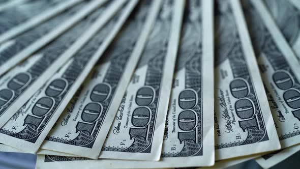 Rich background of one hundred dollars. American money rotating slowly. alt