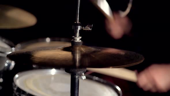 Hands of Musician Drummer Holding Drum Sticks Hitting on Hihat Cymbal alt