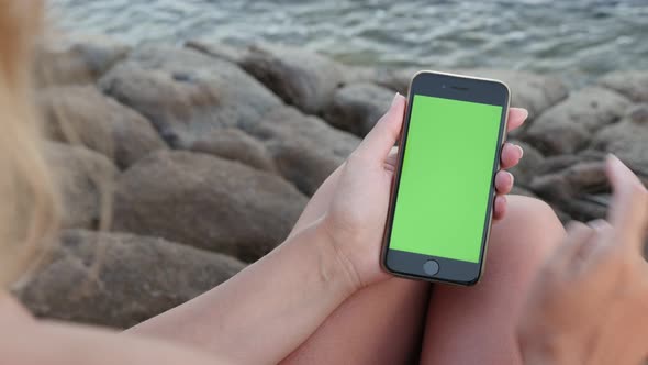 Finger Gestures Over  Green Screen Display on The Sea Beach