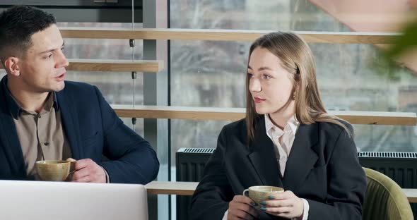 Man and a Woman Discussing Work in the Brightly Lit Modern Office. Male and Female Working with alt