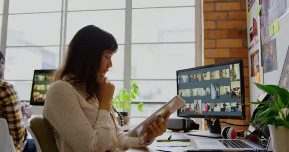 Female graphic designer using digital tablet in a modern office 4k