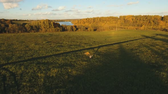 Girl in a Field with a kite. Aerial View alt