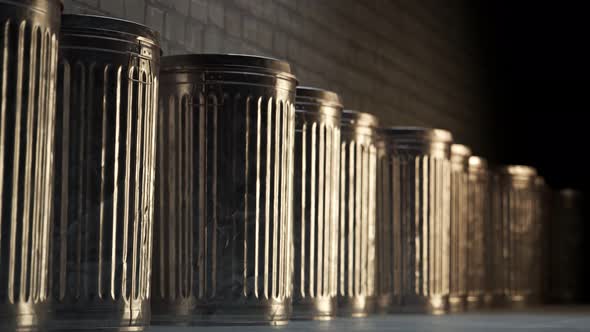 Steel trash bins stacked together in an endless loop lit by dim light. 4K HD