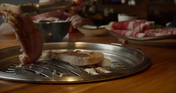 Chief Using the Tong and Turning the Meat on the Grill. Fire Is Burning, Hot Juicy Oil Steak Cooking alt