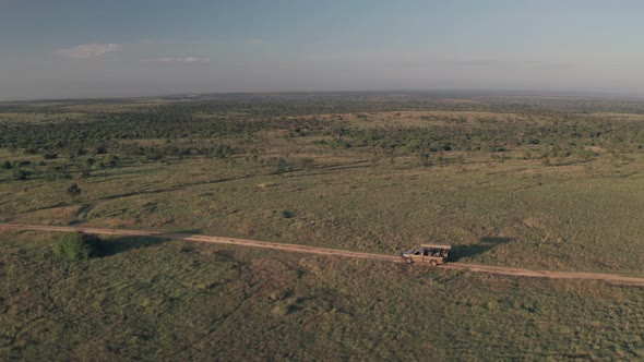 4 wheel drive vehicle on wildlife safari in Kenya. Aerial drone view of safari vacation alt