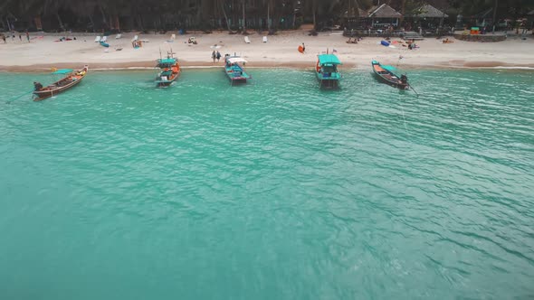 Aerial Flight Moving Away From Tropical Coast Into Se Longtail Boats Azure Water alt