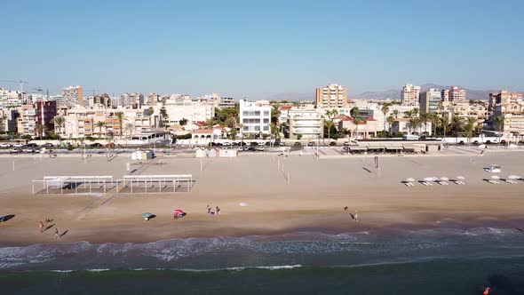 Aerial sideways view of Playa de Muchavista, an urban sandy beach in El Campello, Spain. Mediterrane alt