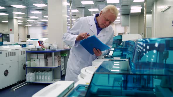 Man Stands Near Laboratory Devices alt