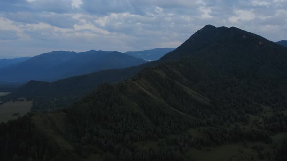 Aerial view from a drone on majestic valley in Altai under sunset sky