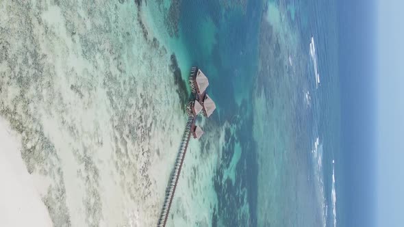 Vertical Video House on Stilts in the Ocean on the Coast of Zanzibar Tanzania Aerial View alt