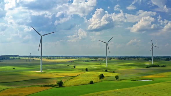 Wind turbines with blue sky in countryside, aerial view in Poland alt