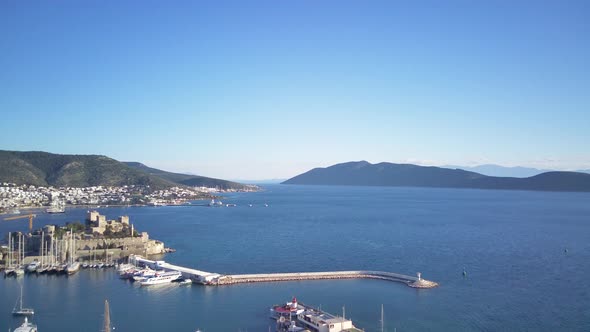 View from drone on full of yachts Bodrum harbour and ancient Kalesi castle in Mugla in Turkey alt
