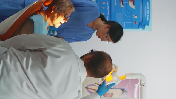 Vertical Video Professional Dentist Working with Gloves During Examination alt