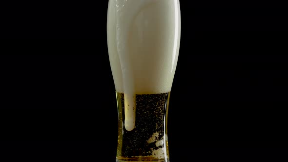 Light Beer In A Glass With Bubbles,Draft Beer In A Glass On A Black Background alt