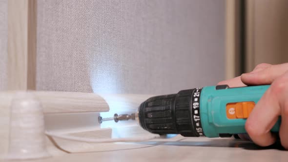 Man Drilling Screws Into Plank alt