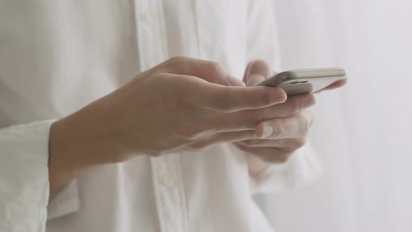 Close up hands businessman scrolling social media feed on smartphone. alt