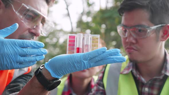 Close up of Ecologist team checks pH value of factory wastewater by Colorimetric method.
