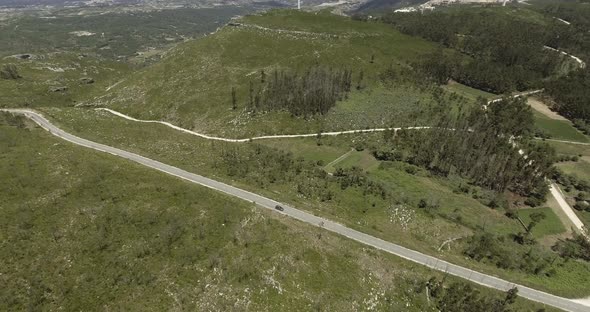 Car Driving On The Long And Winding Road Through Lush Fields In Reguengo Do Fetal Route In Batalha, alt