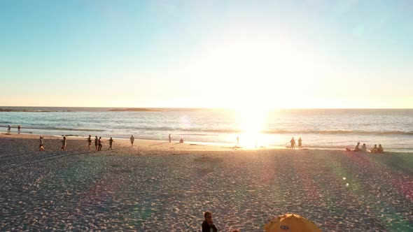 Cinematic Shot of People Having a Good Time at the Beach While the Sun Sets