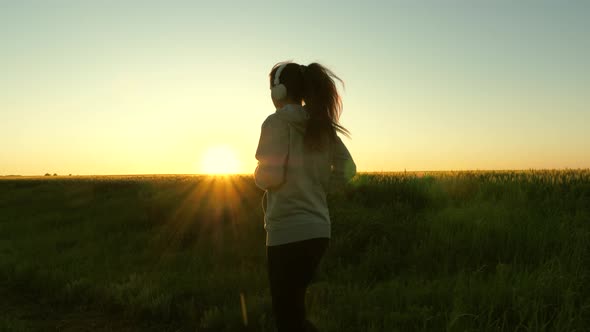 Healthy Beautiful Girl Doing Fitness Jogging on a Wheat Field. Training Run. Free Young Woman Runs alt