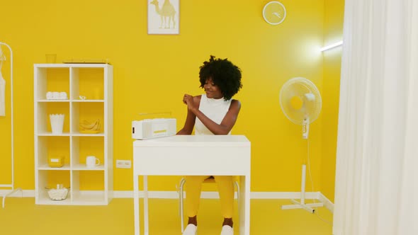 Black Woman Is Listening Music In Yellow Office