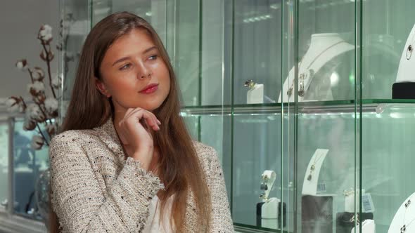 Attractive Young Businesswoman Shopping for Jewelry at the Store alt