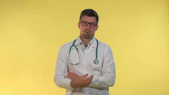 Good-looking Young Doctor in Lab Coat Showing That He Can't Help in This Situation and Spreading alt