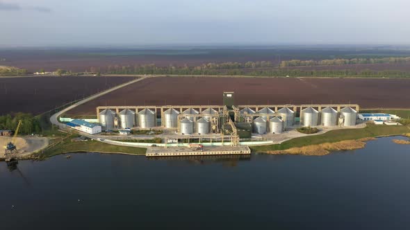 Grain Terminal. Steel Tanks of Elevator Near the River