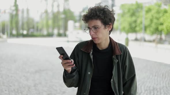 Doubtful Woman Using Cell Phone Outdoor alt