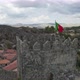 Portuguese Flag at Hilltop towering castle of Sortelha, Portugal. Orbiting shot - VideoHive Item for Sale