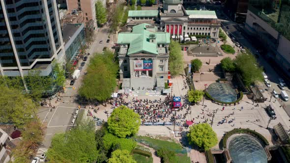 Epic Drone Pullback Reveal of Downtown Vancouver and the Art gallery during an Event on a Sunny Summ alt