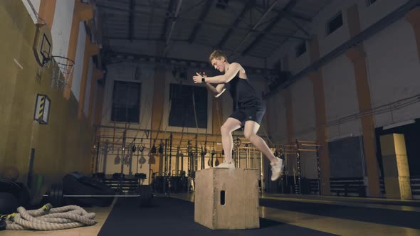 Young Man Jumping on Wooden Box alt