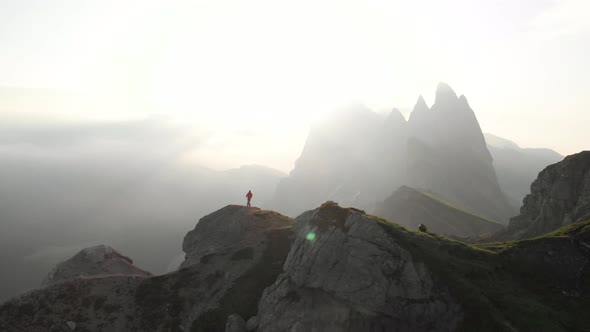 Hiker Walking on Seceda Mountain Peak, Dolomites Italy