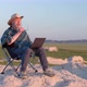 Senior man is working on laptop in the middle of nowhere - VideoHive Item for Sale