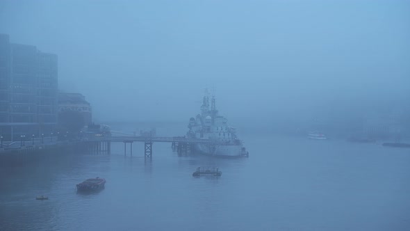 Foggy and misty River Thames and HMS Belfast in London on Coronavirus Covid-19 lockdown day one, in  alt