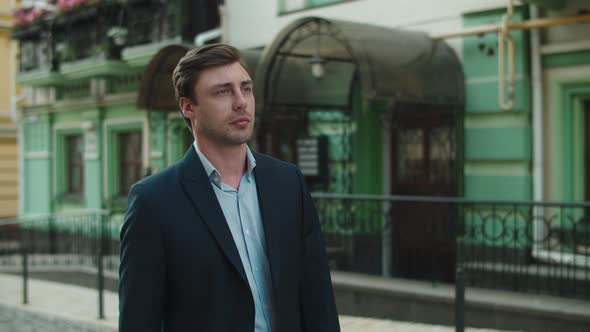 Closeup Businessman Walking at Beautiful Street. Man Looking Away Outdoors alt