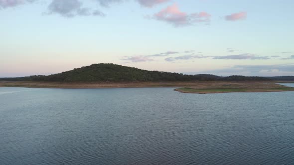 Drone panoramic aerial view of Minutos Dam in Arraiolos Alentejo at sunset, Portugal alt