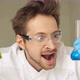 Crazy mad chemist scientist holding test tube with his successful experiment. - VideoHive Item for Sale