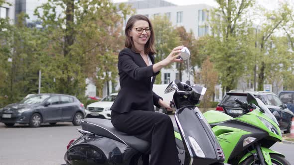Trendy Formal Woman in Suit Sitting on Motorbike