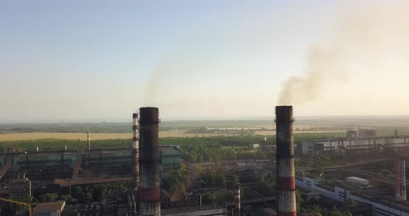 Factory Chimneys With Dark Smoke Pollute The Air, Aerial View