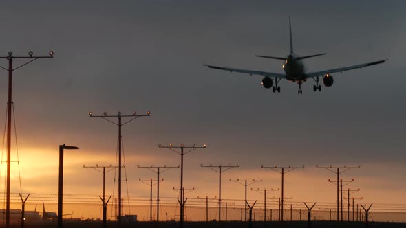 Airplane Landing in LAX Airport at Sunset, Los Angeles, California USA. Passenger Flight or Cargo alt