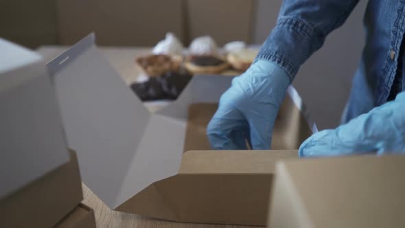 Homemade Pastry Delivery. Cake Shop Business. Woman Putting Cupcakes in Box.